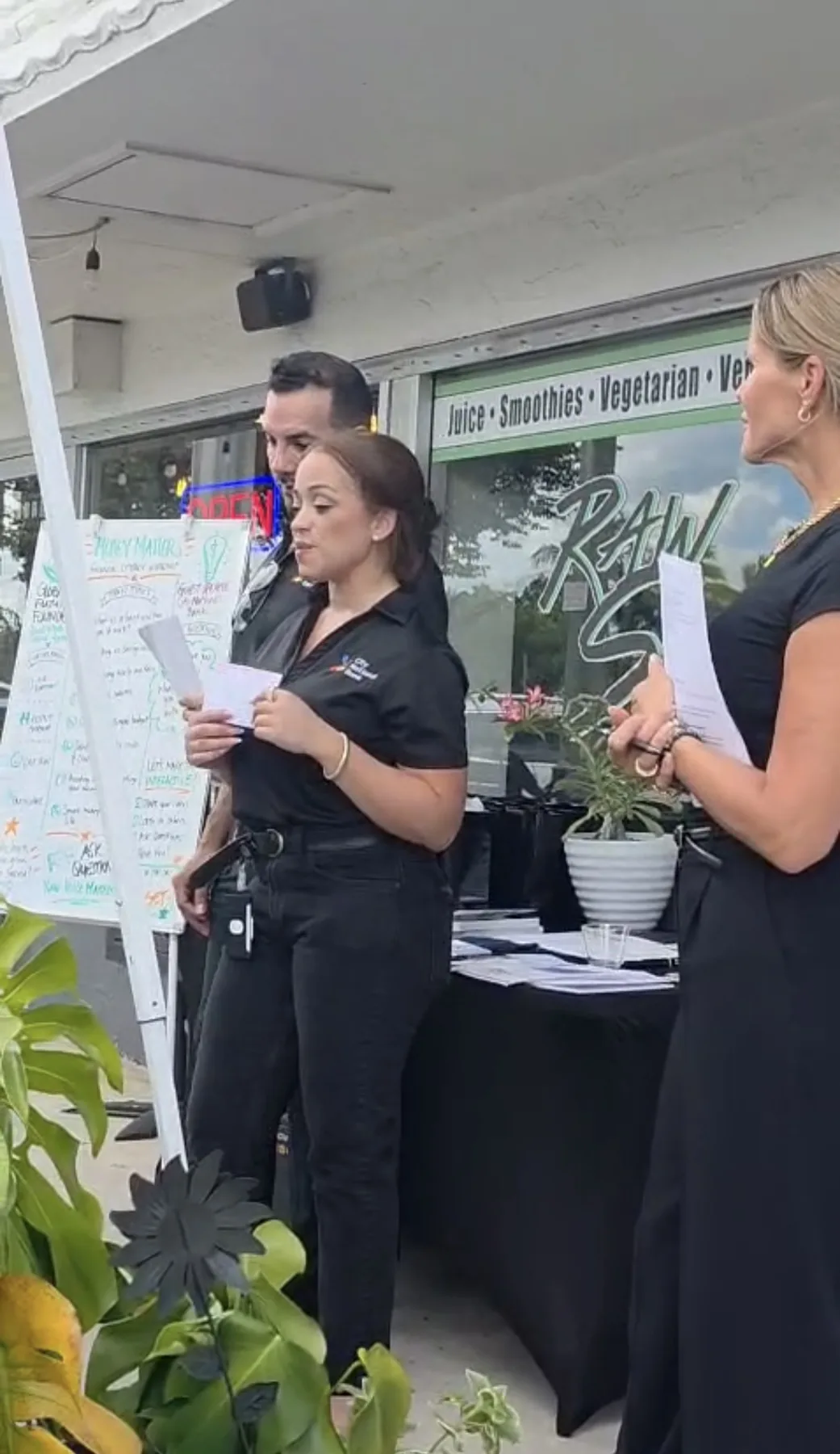 A Future Leaders presenter speaking beside a program board.