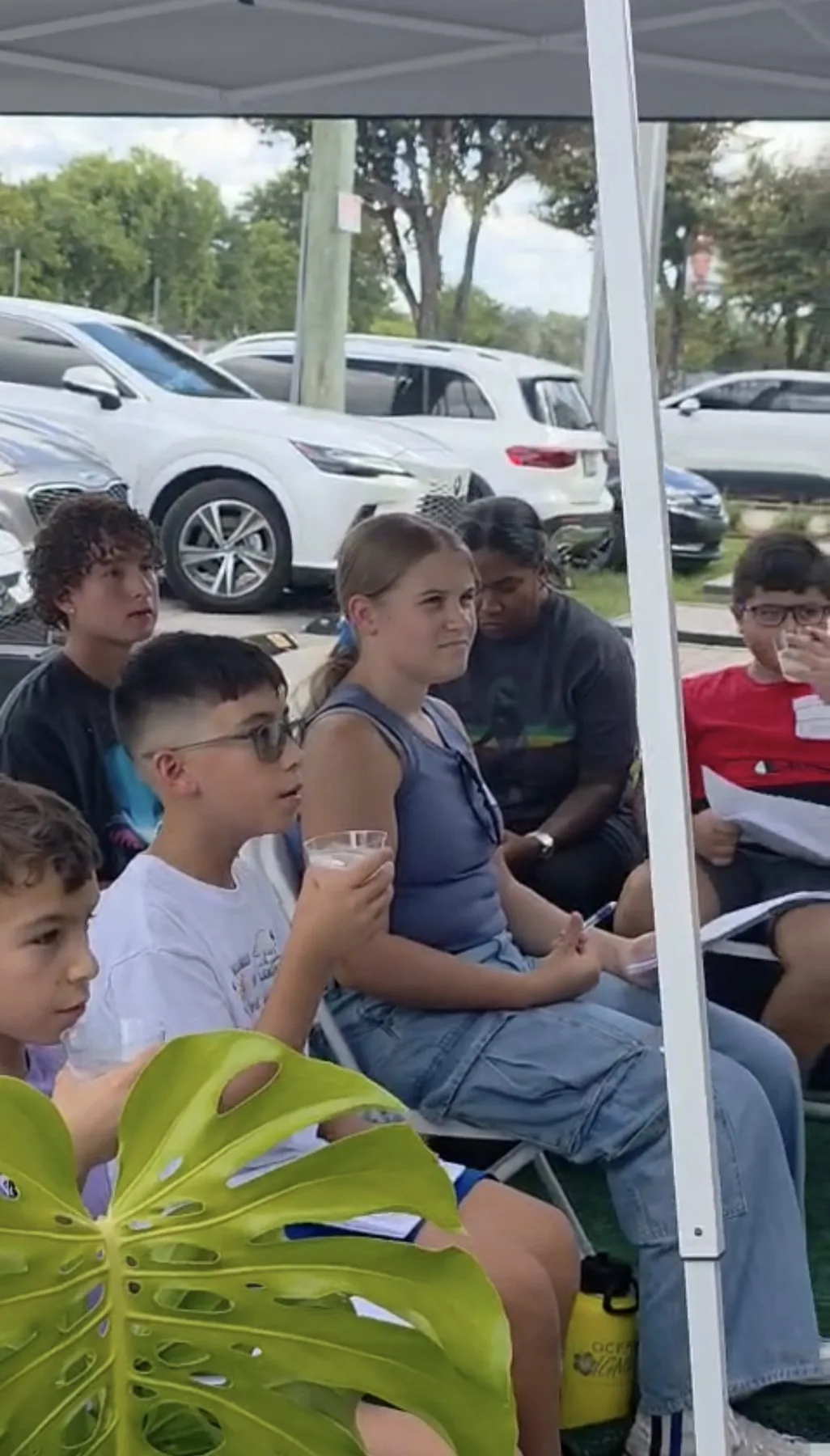 Children seated and listening during a Future Leaders outdoor program.