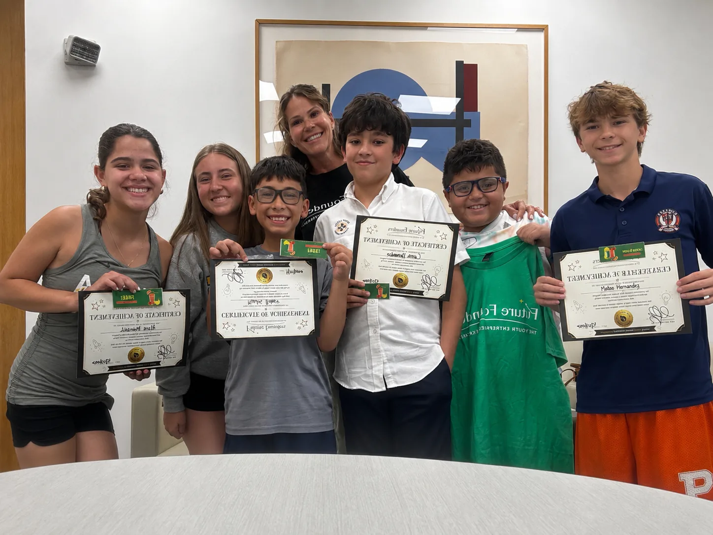 Students holding certificates after a Future Founders session.