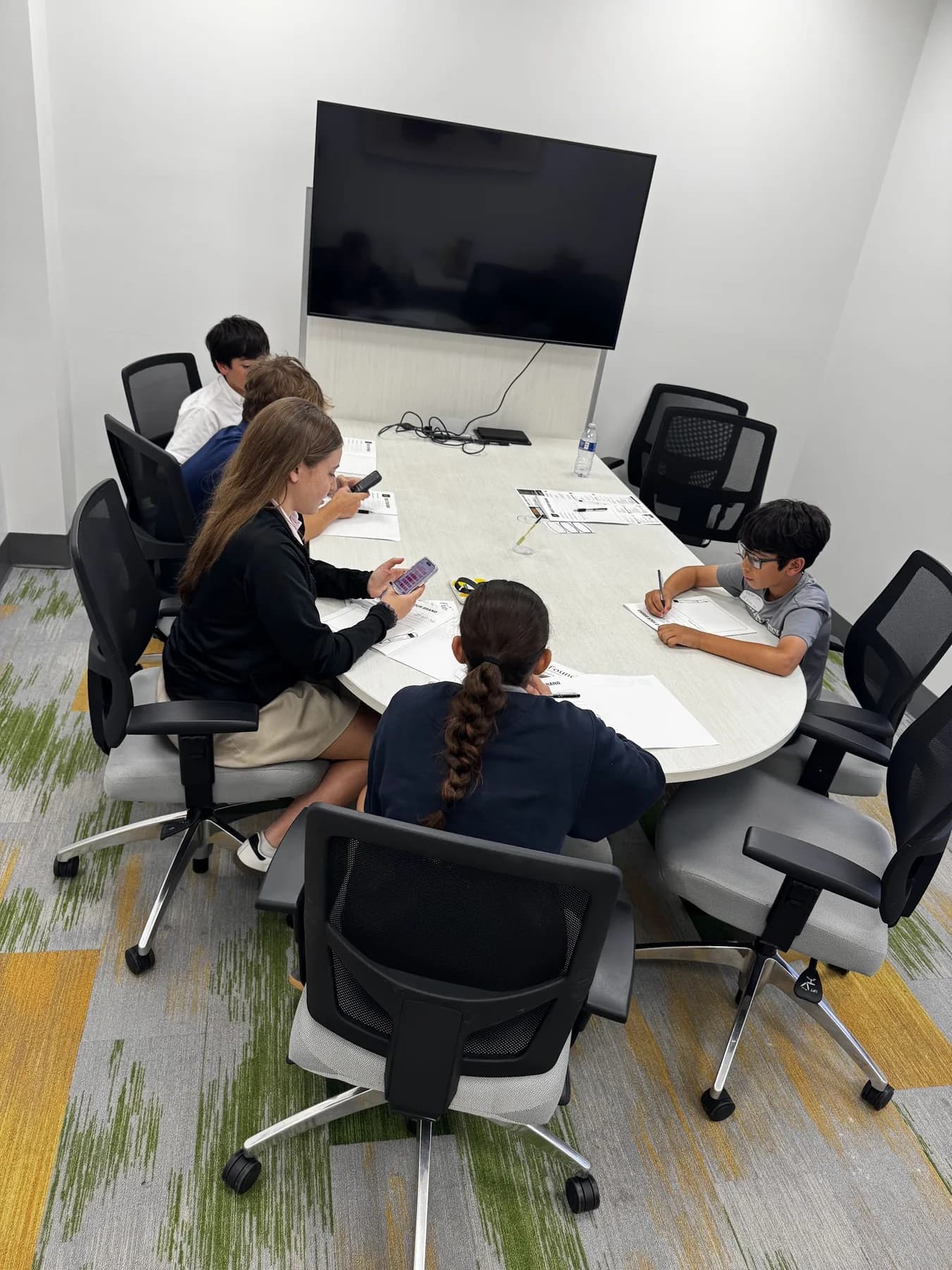 Students gathered around a table during a life-skills session.
