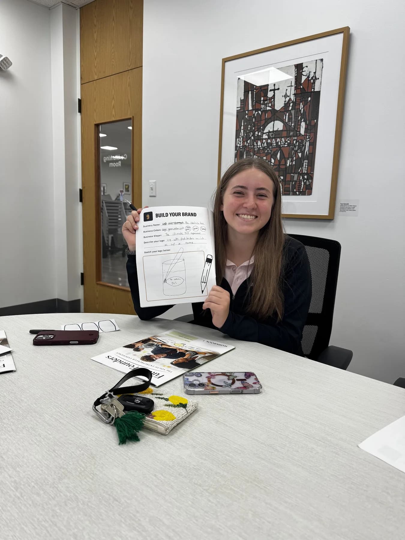 A student holding up a completed Future Founders worksheet.