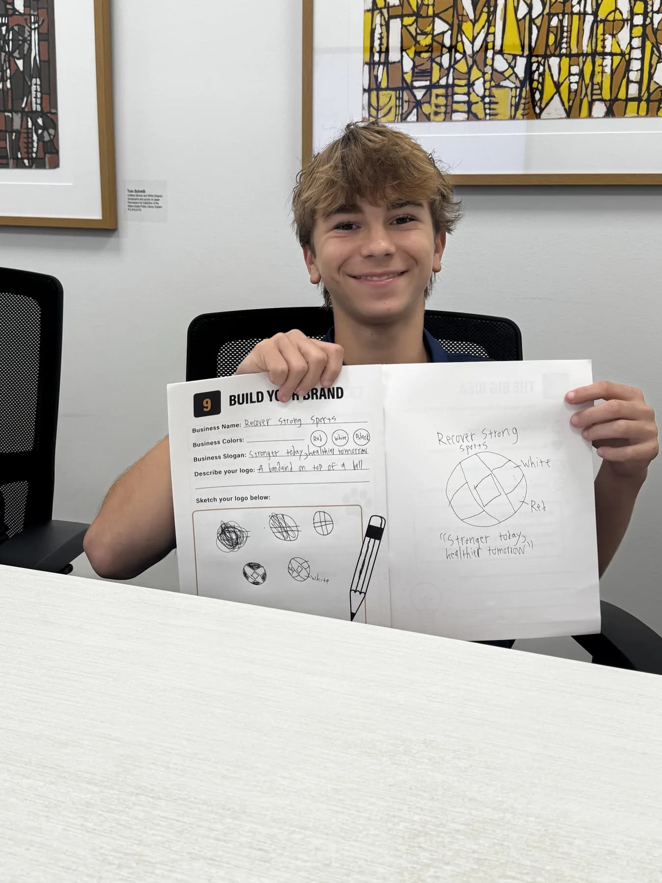 A student presenting a completed worksheet during a Future Founders activity.