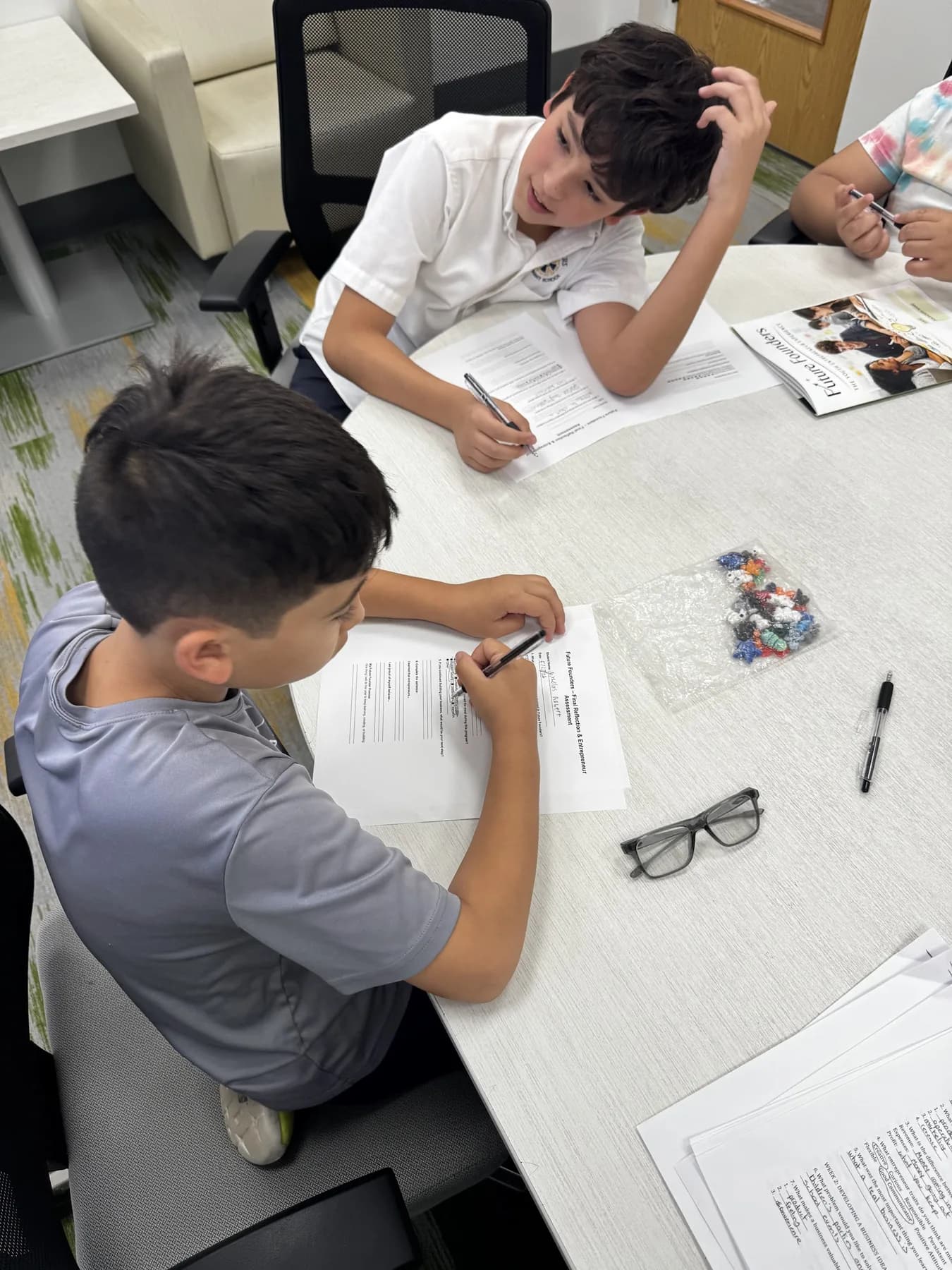 Students writing during a classroom-style Future Founders activity.