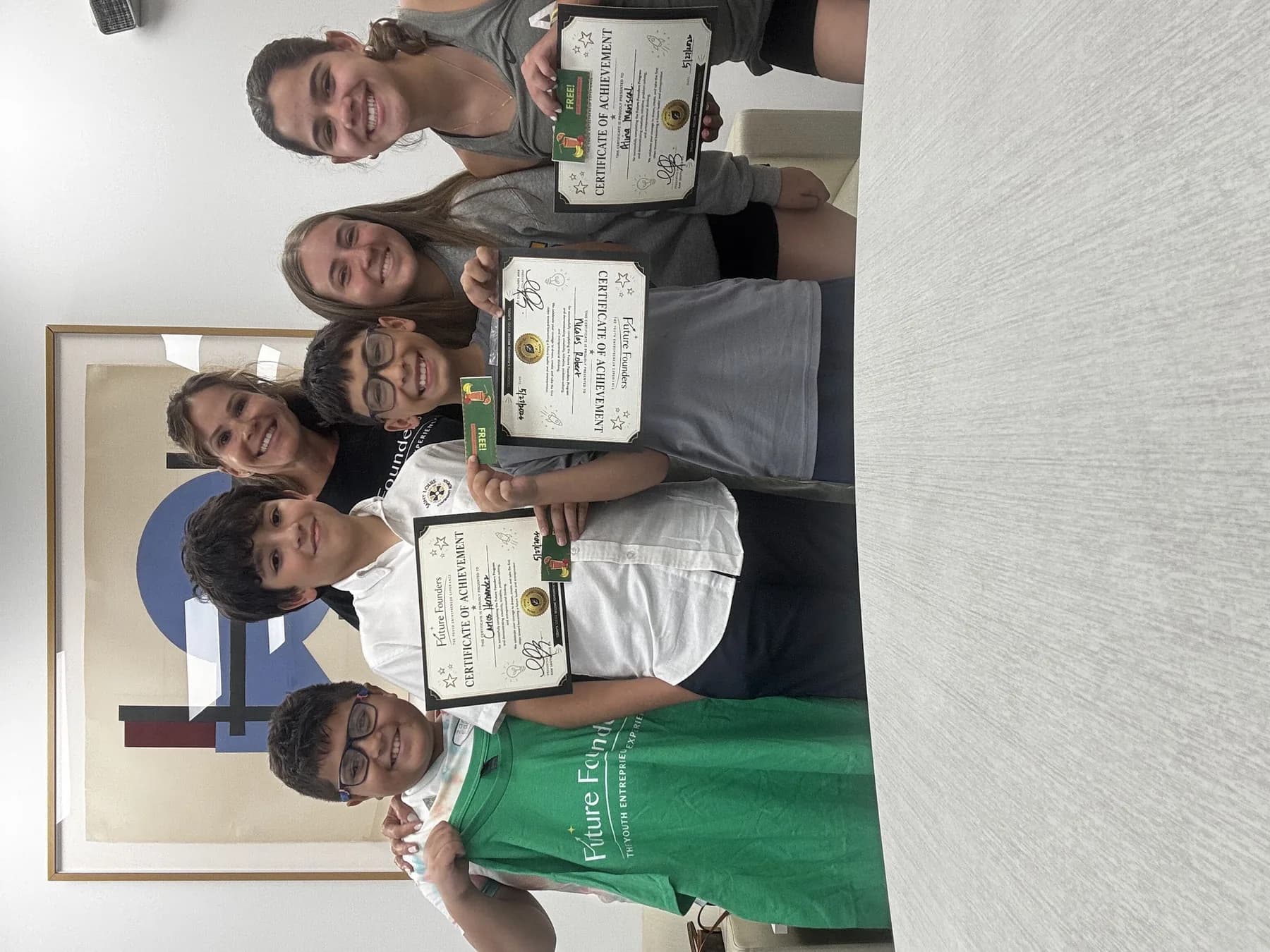 Students gathered with certificates after a Future Founders program session.